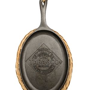 Cast iron skillet and protective basket. Tabasco logo.